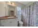 Charming bathroom features neutral walls, vanity, toilet, and paisley shower curtain at 385 Orchard Land, Covington, GA 30014