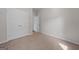 Bedroom featuring neutral walls, neutral carpet, and double doors to a closet or storage space at 385 Orchard Land, Covington, GA 30014