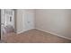 Comfortable bedroom showcases neutral walls, neutral carpet, and double doors to a closet or storage space at 385 Orchard Land, Covington, GA 30014