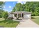 Charming single-story home featuring a welcoming front porch, well-manicured lawn, and attached one car garage at 385 Orchard Land, Covington, GA 30014