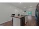 Kitchen with stainless steel appliances, center island, and open layout to the living area with lots of light at 385 Orchard Land, Covington, GA 30014
