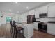 Modern kitchen featuring white cabinets, granite countertops, stainless steel appliances, and an island with bar seating at 385 Orchard Land, Covington, GA 30014