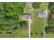 An aerial view of the house with a long driveway and surrounding green trees at 6023 Highway 20 S, Covington, GA 30016
