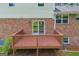 Inviting wooden deck with sliding glass door access, nestled against a brick exterior with green accents at 6023 Highway 20 S, Covington, GA 30016