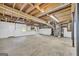 Unfinished basement with utilities, exposed ceiling, and concrete floors at 6023 Highway 20 S, Covington, GA 30016