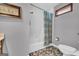 This full bathroom boasts a shower tub combination, gray walls and mosaic tile flooring at 6023 Highway 20 S, Covington, GA 30016