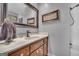 This bathroom boasts a single vanity with gray walls and tile floor at 6023 Highway 20 S, Covington, GA 30016