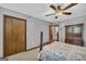 Bedroom featuring a ceiling fan, a double door closet, and a decorative wood bed frame at 6023 Highway 20 S, Covington, GA 30016