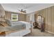 Cozy bedroom with wood paneling, a window, and a vintage vanity at 6023 Highway 20 S, Covington, GA 30016