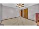 Bedroom featuring a ceiling fan, a double door closet, and neutral gray paint at 6023 Highway 20 S, Covington, GA 30016