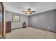 Bedroom featuring a ceiling fan, window, and neutral gray paint at 6023 Highway 20 S, Covington, GA 30016