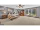 Spacious bedroom with a ceiling fan, decorative lamps, and a large window at 6023 Highway 20 S, Covington, GA 30016