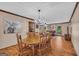 Open concept dining room features wood floors and a modern chandelier at 6023 Highway 20 S, Covington, GA 30016