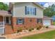 A two-story home featuring brick and vinyl siding, complemented by landscaping and dark shutters at 6023 Highway 20 S, Covington, GA 30016
