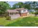 Two-story home with brick and vinyl siding, a front porch, manicured lawn, and an attached garage at 6023 Highway 20 S, Covington, GA 30016