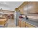 Kitchen with stainless steel refrigerator and vintage wood cabinetry at 6023 Highway 20 S, Covington, GA 30016