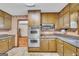 View of kitchen with wood cabinets and stainless steel appliances at 6023 Highway 20 S, Covington, GA 30016