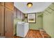Laundry room with washer, dryer, cabinets, and ample storage space at 6023 Highway 20 S, Covington, GA 30016