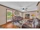 Inviting living room with hardwood floors, plush seating, and large windows offering scenic views at 6023 Highway 20 S, Covington, GA 30016