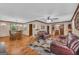 Open-concept living room with hardwood floors, comfortable seating, and seamless transition to the dining area at 6023 Highway 20 S, Covington, GA 30016