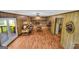 Living room with wood paneling, ceiling fan and brick fireplace at 6023 Highway 20 S, Covington, GA 30016