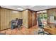 Office area with wood paneling and desk space for two at 6023 Highway 20 S, Covington, GA 30016