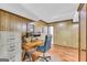 Office featuring a desk, rolling chair, wood paneling, and a window for natural light at 6023 Highway 20 S, Covington, GA 30016