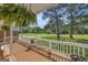 Inviting covered porch features wood flooring, white railings, and hanging plants, providing a relaxing outdoor space at 6023 Highway 20 S, Covington, GA 30016