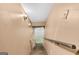 Staircase leading to a unfinished basement and featuring a wood railing at 6023 Highway 20 S, Covington, GA 30016