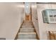 Carpeted staircase featuring a wood railing and a shuttered window at 6023 Highway 20 S, Covington, GA 30016
