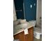 Bathroom with vanity, toilet, and combination tub and shower with a blue accent wall at 9515 Lakeview Rd, Union City, GA 30291