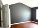 Spacious bedroom with dark gray accent wall, wooden floors, and natural light at 9515 Lakeview Rd, Union City, GA 30291