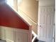 View of stairway with white trim and neutral paint, leading to upper levels with a door at 9515 Lakeview Rd, Union City, GA 30291
