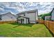 Home exterior showcasing a large backyard with wood privacy fence at 5350 Woodline View Cir, Hoschton, GA 30548