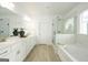 Modern bathroom featuring a dual vanity, a glass-enclosed shower, and sleek fixtures at 5350 Woodline View Cir, Hoschton, GA 30548
