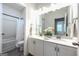 Bright bathroom featuring a dual vanity, ample storage, and shower and tub combo at 5350 Woodline View Cir, Hoschton, GA 30548