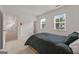 Comfortable bedroom with plenty of natural light, spacious layout and view of exterior at 5350 Woodline View Cir, Hoschton, GA 30548
