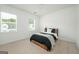 Contemporary bedroom featuring a modern bed, bright natural light, and comfortable decor at 5350 Woodline View Cir, Hoschton, GA 30548