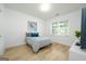 Cozy bedroom with a comfortable bed, stylish artwork, and ample natural light at 5350 Woodline View Cir, Hoschton, GA 30548