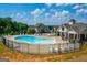 Community pool with ample seating, lounge chairs, clubhouse, and lush landscaping creating a relaxing atmosphere at 5350 Woodline View Cir, Hoschton, GA 30548