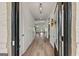 Grand entryway featuring hardwood floors, decorative lighting, and a welcoming open floor plan at 5350 Woodline View Cir, Hoschton, GA 30548