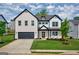 Charming two-story home featuring a brick facade, attached garage, and beautifully landscaped front yard at 5350 Woodline View Cir, Hoschton, GA 30548