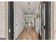 Bright foyer showcasing hardwood floors, white trim, and an open view to the living spaces at 5350 Woodline View Cir, Hoschton, GA 30548
