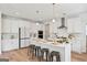Modern kitchen with white cabinets, a large island, and stainless steel appliances at 5350 Woodline View Cir, Hoschton, GA 30548