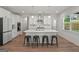Modern kitchen with stainless steel appliances, a large island, pendant lighting, and ample cabinet space at 5350 Woodline View Cir, Hoschton, GA 30548
