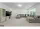 Spacious living room with a large sectional sofa and entertainment center at 5350 Woodline View Cir, Hoschton, GA 30548