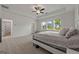 Spacious bedroom with tray ceiling and a large window providing natural light to the interior at 5350 Woodline View Cir, Hoschton, GA 30548