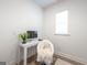 Bright office features a modern desk, comfortable chair, and natural light from the window at 5350 Woodline View Cir, Hoschton, GA 30548