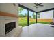 Covered patio features an outdoor fireplace, ceiling fan and views of the fenced backyard at 5350 Woodline View Cir, Hoschton, GA 30548