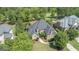 Stunning aerial view of a well-maintained home with lush landscaping and a pristine golf course in the background at 719 Bethpage Dr, Mcdonough, GA 30253